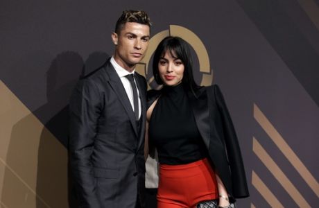 Real Madrid player Cristiano Ronaldo and his girlfriend Georgina Rodriguez pose for photos as they arrive for the Portuguese soccer federation awards ceremony Monday, March 19, 2018, in Lisbon. (AP Photo/Armando Franca)