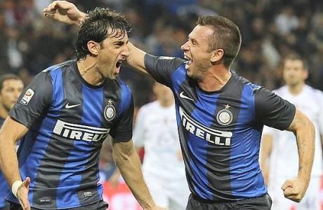 Inter Milan Argentine forward Diego Milito, left, celebrates with his teammate forward Antonio Cassano after scoring during a Serie A soccer match between Inter Milan and Fiorentina, at the San Siro stadium in Milan, Italy, Sunday, Sept. 30, 2012. (AP Photo/Luca Bruno)