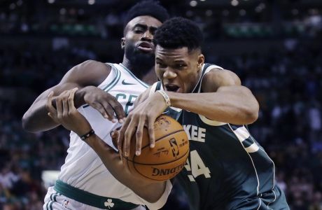 Milwaukee Bucks forward Giannis Antetokounmpo, right, tries to drive past Boston Celtics forward Jaylen Brown, left, during the first quarter of an NBA basketball game, Wednesday, Oct. 18, 2017, in Boston. (AP Photo/Charles Krupa)