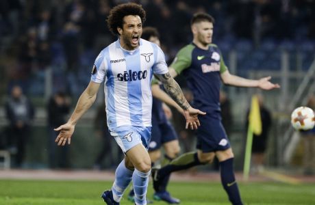 Lazio's Felipe Anderson, left, celebrates after scoring his side's third goal during a Europa League quarterfinal first leg soccer match between Lazio and FC Red Bull Salzburg in Rome, Thursday, April 5, 2018. (AP Photo/Gregorio Borgia)