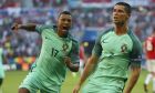 Portugal's Cristiano Ronaldo celebrates with his teammate Nani, left, after scoring his side's second goal during the Euro 2016 Group F soccer match between Hungary and Portugal at the Grand Stade in Decines-­Charpieu, near Lyon, France, Wednesday, June 22, 2016. (AP Photo/Darko Bandic)