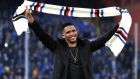 Samuel Eto'o salutes Sampdoria supporters at the end of a Serie A soccer match between Sampdoria and Palermo, in Genoa, Italy, Sunday, Jan. 25, 2015. In Genoa, all eyes were on the stands, where club president Massimo Ferrero sat with a smiling Eto'o and fellow new signing Luis Muriel, with all three wearing Sampdoria scarves. No official comment has been made by either Sampdoria or Everton but Eto'o underwent a successful medical this weekend and will reportedly be presented to the media on Monday after the deal has been finalized. (AP Photo/Carlo Baroncini)