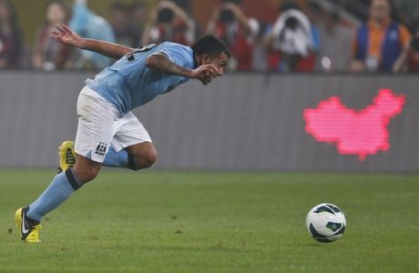 Manchester City's Carlos Tevez goes for the ball during a friendly match against Arsenal at China's National Stadium in Beijing, July 27, 2012. Manchester City won 2-0. (AP Photo/Alexander F. Yuan)