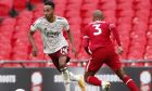 Arsenal's Pierre-Emerick Aubameyang, left, duels for the ball with Liverpool's Fabinho during the English FA Community Shield soccer match between Arsenal and Liverpool at Wembley stadium in London, Saturday, Aug. 29, 2020. (Andrew Couldridge/Pool via AP)