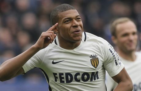 FILE - In this March 19, 2017, file photo, Monaco's Kylian Mbappe celebrates with teammates after he scored the first goal during their French League One soccer match against Caen, in Caen, north western France. Monaco's young players have made such an impression  particularly striker Kylian Mbappe  that offers will be flooding in when the transfer window reopens. In the Principality famed for its casino, Monaco will have to choose whether or not to cash in its chips this summer and rake in a huge amount. (AP Photo/David Vincent, File)