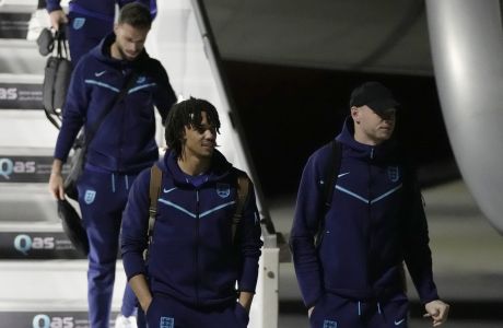 Trent Alexander-Arnold, left, of England's national soccer team arrives with teammates at Hamad International Airport in Doha, Qatar, Tuesday, Nov. 15, 2022, ahead of the upcoming World Cup. England will play their first match in the World Cup against Iran on Nov. 21. (AP Photo/Hassan Ammar)