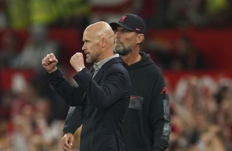 Manchester United's head coach Erik ten Hag celebrates at the end the English Premier League soccer match between Manchester United and Liverpool at Old Trafford stadium, in Manchester, England, Monday, Aug 22, 2022. In background is Liverpool's manager Jurgen Klopp. (AP Photo/Dave Thompson)