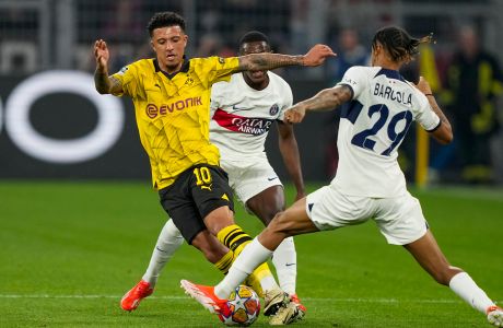 PSG's Bradley Barcola, right, and Dortmund's Jadon Sancho compete for the ball during the Champions League semifinal first leg soccer match between Borussia Dortmund and Paris Saint-Germain at the Signal-Iduna Park in Dortmund, Germany, Wednesday, May 1, 2024. (AP Photo/Martin Meissner)