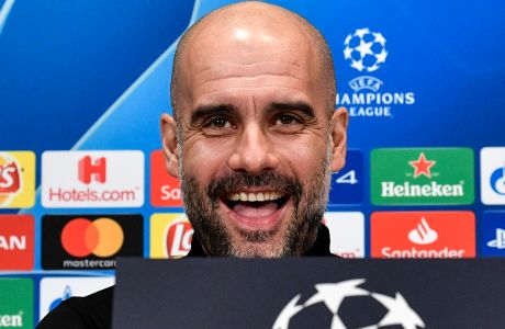 Manchester City manager Pep Guardiola smiles to the media during a press conference prior the Champions League round of 16, first leg, soccer match between FC Schalke 04 and Manchester City in Essen, Germany, Tuesday, Feb. 19, 2019. (AP Photo/Martin Meissner)