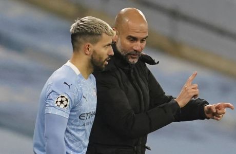 Manchester City's head coach Pep Guardiola, right, gives instruction to Manchester City's Sergio Aguero during the Champions League, Group C, soccer match between Manchester City and Marseille at the Etihad stadium in Manchester in London Wednesday, Dec. 9, 2020. (AP Photo/Jon Super)