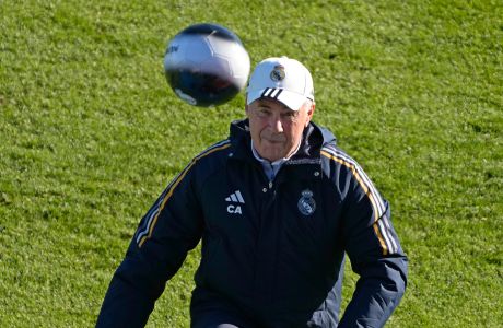 Real Madrid's head coach Carlo Ancelotti kicks a ball into the crowd during an open day training session, the last of the year, in Madrid, Spain, Saturday, Dec. 30, 2023. Real Madrid has extended Carlo Ancelotti's contract until 2026, seemingly ending Brazil's hopes of hiring him as the new national coach. (AP Photo/Paul White)