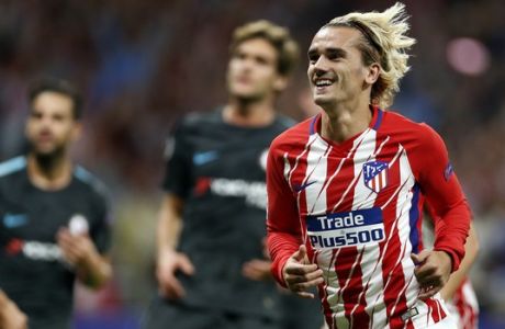 Atletico's Antoine Griezmann, front, celebrates after scoring the penalty opening goal during a Champions League group C soccer match between Atletico Madrid and Chelsea at the Wanda Metropolitano stadium in Madrid, Spain, Wednesday, Sept. 27, 2017. (AP Photo/Francisco Seco)