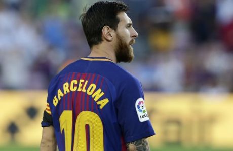 Barcelona's Lionel Messi wears a shirt with 'Barcelona' on his back instead of his name as did all Barcelona players to pay homage to the van attack victims before a La Liga soccer match between Barcelona and Betis at the Camp Nou stadium in Barcelona, Spain, Sunday, Aug. 20, 2017. Security was stepped up for the match after a terror attack that killed 14 people and wounded over 120 in Barcelona and police put up scores of roadblocks across northeast Spain on Sunday in hopes of capturing a fugitive suspect at large following the vehicle attack.(AP Photo/Manu Fernandez)