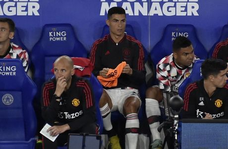 Manchester United's Cristiano Ronaldo, center, sits on the bench during the English Premier League soccer match between Leicester City and Manchester United at King Power stadium in Leicester, England, Thursday, Sept. 1, 2022. (AP Photo/Rui Vieira)