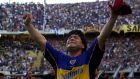 Argentine soccer ace Diego Maradona waves to the crowd wearing the shirt of his former club Boca Juniors at the end of his farewell game in Buenos Aires, Argentina Saturday, Nov. 10, 2001. (AP Photo/Mario Cocchi)