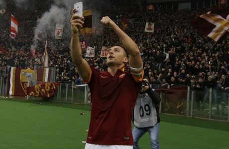 Roma's Francesco Totti celebrates after scoring during a Serie A soccer match between Roma and Lazio at Rome's Olympic stadium, Sunday, Jan. 11, 2015. (AP Photo/Gregorio Borgia)