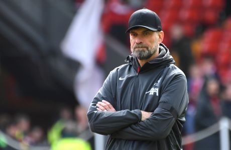 Liverpool's manager Jurgen Klopp watches his players prior to the English Premier League soccer match between Liverpool and Brighton and Hove at Anfield Stadium in Liverpool, England, Sunday, March 31, 2024. (AP Photo/Rui Vieira)