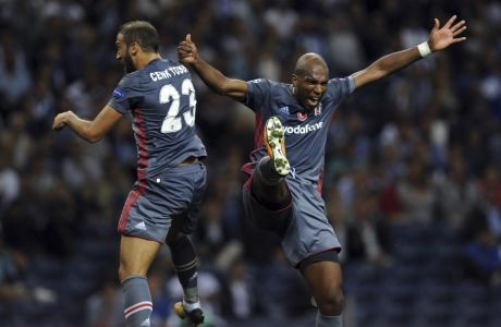 Besiktas' Ryan Babel, right, celebrates with teammate Cenk Tosun after scoring his side's third goal during the Champions League group G soccer match between FC Porto and Besiktas at the Dragao stadium in Porto, Portugal, Wednesday, Sept. 13, 2017. (AP Photo/Paulo Duarte)