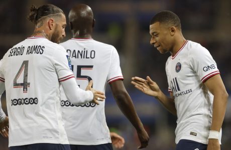 PSG's Kylian Mbappe, right, celebrates with teammate PSG's Sergio Ramos after scoring his side's opening goal during the French League One soccer match between Strasbourg and Paris Saint-Germain at Stade de la Meinau stadium in Strasbourg, eastern France, Friday, April 29, 2022. (AP Photo/Jean-Francois Badias)