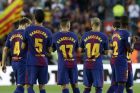 Barcelona players applaud after observing a minute of silence for the victims of the van attacks before a La Liga soccer match between Barcelona and Betis at the Camp Nou stadium in Barcelona, Spain, Sunday, Aug. 20, 2017. Security was stepped up for the match after a terror attack that killed 14 people and wounded over 120 in Barcelona and police put up scores of roadblocks across northeast Spain on Sunday in hopes of capturing a fugitive suspect at large following the vehicle attack. Barcelona players are all wearing shirts with 'Barcelona' on their backs tonight, rather than their names to pay homage to the van attack victims. (AP Photo/Manu Fernandez)