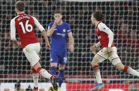 Arsenal's Hector Bellerin, right, celebrates scoring his side's second goal during the English Premier League soccer match between Arsenal and Chelsea at Emirates stadium in London, Wednesday, Jan. 3, 2018. (AP Photo/Frank Augstein)