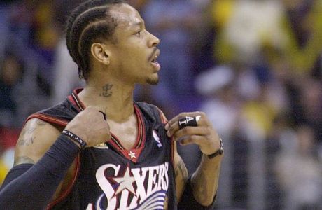The Philadelphia 76ers' Allen Iverson, left, argues with the Los Angeles Lakers' Kobe Bryant at the end of Game 2 of the NBA Finals in Los Angeles, Friday, June 8, 2001. Iverson complained that the Lakers were holding him during the game.  The 76ers' Raja Bell looks on at rear. The Lakers went on to win 98-89 to even the series at 1-1.  (AP Photo/Kim D. Johnson)