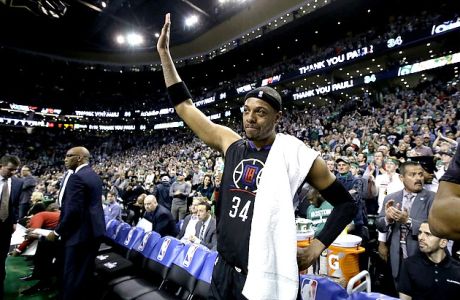 Los Angeles Clippers forward Paul Pierce, center, acknowledges applause from the crowd during a timeout in the first half of an NBA basketball game against the Boston Celtics, Sunday, Feb. 5, 2017, in Boston. Pierce, a former Celtics player, played in what is expected to be his final game in Boston Sunday. (AP Photo/Steven Senne)