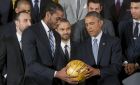 President Barack Obama is presented an autographed basket by San Antonio Spurs forward Kawhi Leonard as he honored the 2014 NBA Champions the San Antonio Spurs basketball team during a ceremony in the East Room White House in Washington, Monday, Jan. 12, 2015. (AP Photo/Pablo Martinez Monsivais)