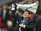 Argentina soccer legend Diego Armando Maradona waves a shirt during halftime of the English Premier League soccer match between Tottenham Hotspur and Liverpool at Wembley Stadium in London, Sunday, Oct. 22, 2017.(AP Photo/Frank Augstein)