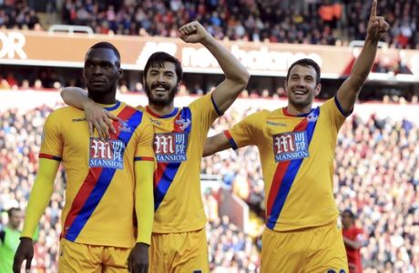 Crystal Palace's Christian Benteke, left, celebrates scoring against Liverpool with teammates during the English Premier League soccer match at Anfield, Liverpool, Sunday April 23, 2017. (Peter Byrne/PA via AP)