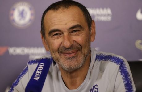 Chelsea's recently appointed head coach Maurizio Sarri, from Italy, smiles during a press conference at their facilities in Stoke d'Abernon, on the outskirts of south west London, Friday, Aug. 3, 2018. Sarri was speaking to preview their Community Shield soccer match against Manchester City on Sunday. (AP Photo/Matt Dunham)