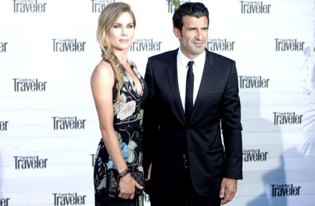 Swedish model Helen Swedin and Portuguese former footballer Luis Figo pose for photographers during the photocall of the 'Conde Nast Traveler Awards' in Madrid, Spain on Thursday, May 7, 2015. (AP Photo/Abraham Caro Marin)

