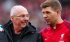 Former England manager Sven-Goran Eriksson stands alongside Steven Gerrard before the start of an exhibition soccer match between Liverpool Legends and Ajax Legends at Anfield Stadium, Liverpool, England, Saturday March 23, 2024. Former England boss Eriksson, who is a lifelong Liverpool fan, disclosed his terminal cancer diagnosis in January. (AP Photo/Jon Super)
