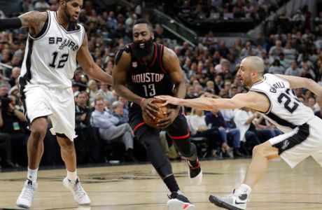 Houston Rockets guard James Harden (13) drives between San Antonio Spurs forward LaMarcus Aldridge (12) and guard Manu Ginobili (20) during the first half of Game 1 of a second-round NBA playoff series basketball game, Monday, May 1, 2017, in San Antonio. (AP Photo/Eric Gay)