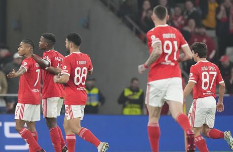 Benfica's David Neres, left, celebrates after scoring his side's fifth goal during the Champions League, round of 16, second leg soccer match between Benfica and Club Brugge at the Luz stadium in Lisbon, Portugal, Tuesday, March 7, 2023. (AP Photo/Armando Franca)
