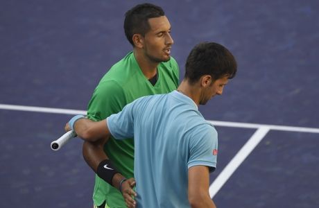 Nick Kyrgios, of Australia, top, shakes hands with Novak Djokovic, of Serbia, after Kyrgios beat Djokovic at the BNP Paribas Open tennis tournament, Wednesday, March 15, 2017, in Indian Wells, Calif. (AP Photo/Mark J. Terrill)