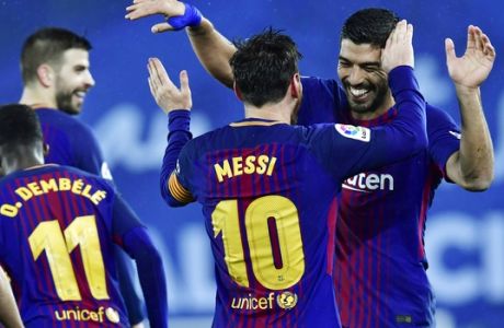FC Barcelona's Lionel Messi celebrates with Luis Suarez, right, after scoring the fourth goal of his team during the Spanish La Liga soccer match between Barcelona and Real Sociedad, at Anoeta stadium, in San Sebastian, northern Spain, Sunday, Jan.14, 2018. (AP Photo/Alvaro Barrientos)