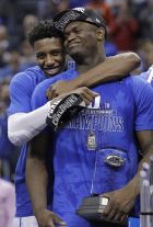 Duke's RJ Barrett, left, hugs Zion Williamson after Duke defeated Florida State in the NCAA college basketball championship game of the Atlantic Coast Conference tournament in Charlotte, N.C., Saturday, March 16, 2019. (AP Photo/Nell Redmond)