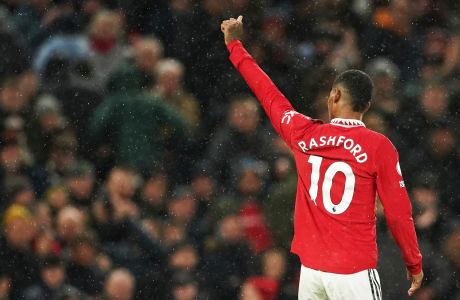Manchester United's Marcus Rashford celebrates after scoring his side's third goal during the English Premier League soccer match between Manchester United and Bournemouth at Old Trafford in Manchester, England, Tuesday, Jan. 3, 2023. (AP Photo/Dave Thompson)