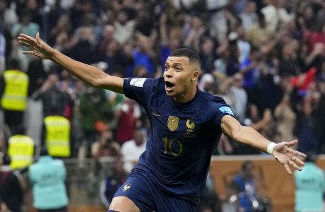 France's Kylian Mbappe celebrates scoring from the penalty spot his side's third goal during the World Cup final soccer match between Argentina and France at the Lusail Stadium in Lusail, Qatar, Sunday, Dec. 18, 2022. (AP Photo/Natacha Pisarenko)