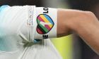 FILE - England's Harry Kane, center, wearing a rainbow armband, controls the ball during the UEFA Nations League soccer match between Italy and England at the San Siro stadium, in Milan, Italy, on Sept. 23, 2022. The captains of seven European nations will not wear anti-discrimination armbands in World Cup games after threats from FIFA to show yellow cards to the players. The seven soccer federations say "we cant put our players in a position where they could face sporting sanctions. (AP Photo/Antonio Calanni, File)