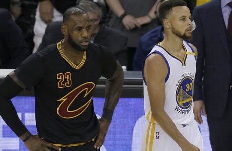 Cleveland Cavaliers forward LeBron James (23) and Golden State Warriors guard Stephen Curry (30) during the first half of Game 5 of basketball's NBA Finals in Oakland, Calif., Monday, June 12, 2017. (AP Photo/Ben Margot)