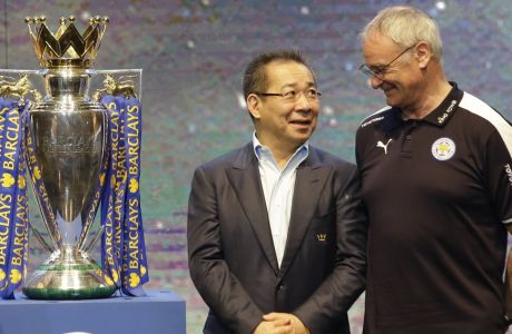 FILE - In this Wednesday, May 18, 2016 file photoLeicester City's chairman Vichai Srivaddhanaprabha, left, talks to Leicester City's Manager Claudio Ranieri beside the English Premier League soccer champions trophy during a press conference in Bangkok, Thailand. Leicester City announced Thursday, Feb. 23, 2017 that they have sacked manager Claudio Ranieri less than a year after their incredible run to the Premier League title. (AP Photo/Sakchai Lalit, File)