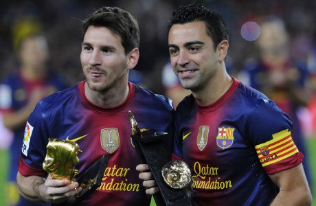FC Barcelona's Lionel Messi from Argentina, left, hold the European Golden Boot 2012 award for best European goalscorer of the 2011-2012 season and Xavi Hernandez holds the Spain's prestigious Asturias prize before a Spanish La Liga soccer match a at the Camp Nou stadium in Barcelona, Spain, Saturday, Nov. 3, 2012. (AP Photo/Manu Fernandez)