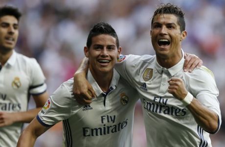 Real Madrid's Cristiano Ronaldo, right, celebrates with teammate James Rodriguez after scoring their side's second goal against Sevilla during the La Liga soccer match between Real Madrid and Sevilla at the Santiago Bernabeu stadium in Madrid, Sunday, May 14, 2017. (AP Photo/Francisco Seco)