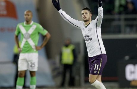 Everton's Kevin Mirallas celebrates scoring his side's 2nd goal during the Europa League Group H soccer match between VfL Wolfsburg and Everton FC at the Volkswagen Arena stadium in Wolfsburg, Germany, Thursday, Nov. 27, 2014. At left is Wolfsburg's Naldo. (AP Photo/Michael Sohn)