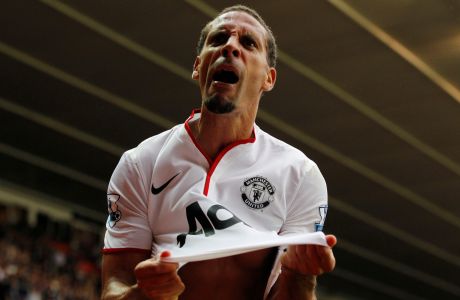 Manchester United's Rio Ferdinand reacts to Robin Van Persie's third goal against Southampton during their English Premier League soccer match at St Mary's stadium, Southampton, England, Sunday, Sept. 2, 2012. (AP Photo/Sang Tan)