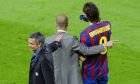 Milan's coach Jose Mourinho, left, touches the back of Barcelona's coach Pep Guardiola, cente, during the Champions League semifinal second leg soccer match between FC Barcelona and Inter Milan at the Camp Nou stadium in Barcelona, Spain, Wednesday, April 28, 2010. (AP Photo/Manu Fernandez)