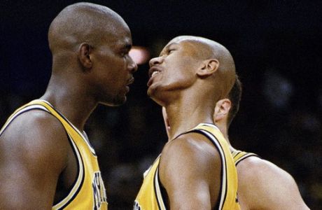 FILE - In this file photo April 6, 1993, Michigan's Chris Webber, left, and Jalen Rose talk during their NCAA championship game with North Carolina at the Superdome in New Orleans. Former college basketball star and ex-NBA player Rose said an upcoming ESPN film will be an in-depth look at the University of Michigan's Fab 5. (AP Photo/Paul Sancya, File)