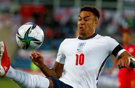 England's Jesse Lingard goes for the ball during the World Cup 2022 group I qualifying soccer match between Andorra and England at the National Stadium in Andorra la Vella, Saturday, Oct. 9, 2021. Manchester United manager Ralf Rangnick says Mason Greenwoods suspension played a role in the clubs decision to keep Jesse Lingard until the end of the season. Greenwood was arrested on Sunday and questioned on suspicion of the rape and assault of a woman. He was released on bail on Wednesday and United has said the 20-year-old forward will not train with, or play for, the club until further notice. (AP Photo/Joan Monfort)